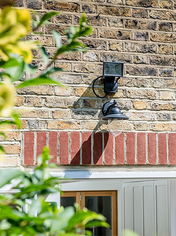 outside area at the back of the house with close-up of light fixture