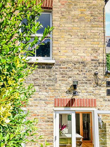 Outside area at the back of the house overlooking entry and window