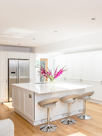 White kitchen and island with bar stools