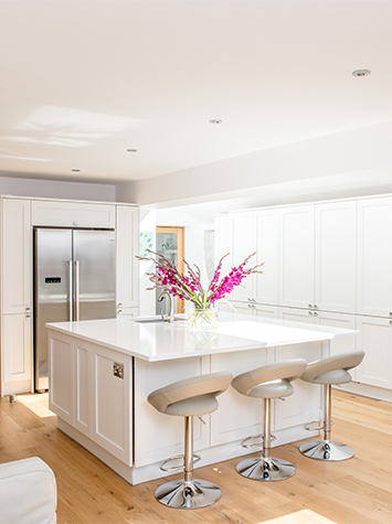 white kitchen with three bar stools