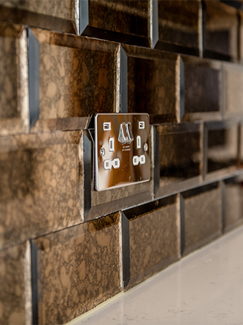 close-up of kitchen socket and splashback