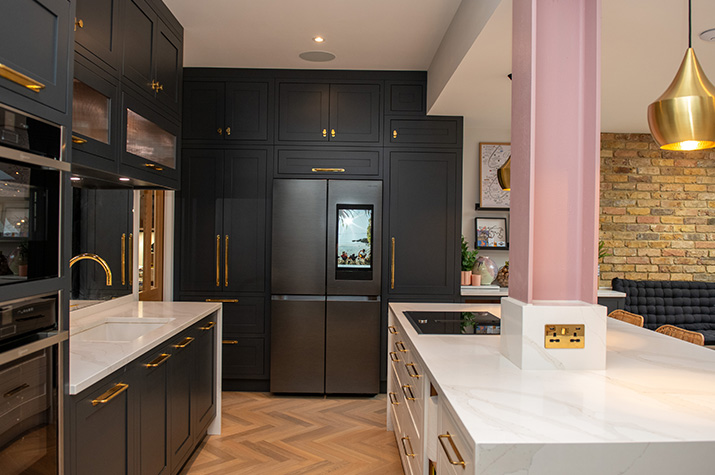 kitchen with view of fridge and black cupboards