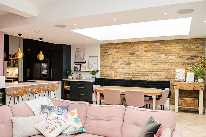 living room with a pink sofa and dining table